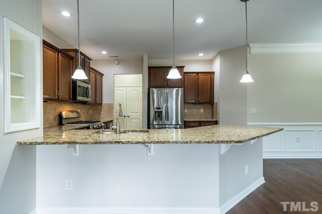 4713 Gaelic Trail Raleigh, NC 27604 - Photo 10 of 26 a view of a kitchen counter space a sink and a refrigerator