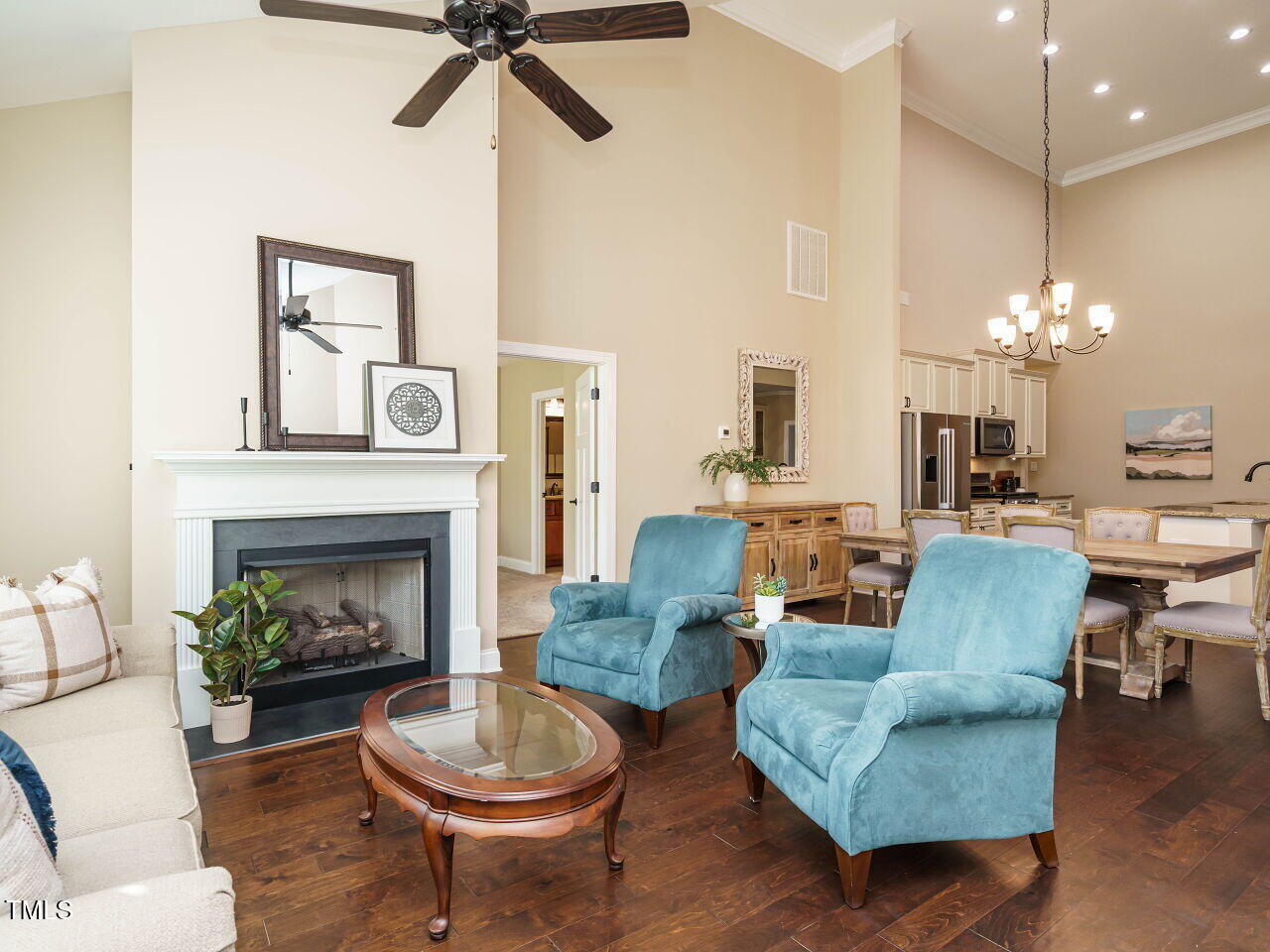 116 Telluride Trail Garner, NC 27529 - Photo 12 of 40 a living room with furniture a fireplace and a chandelier