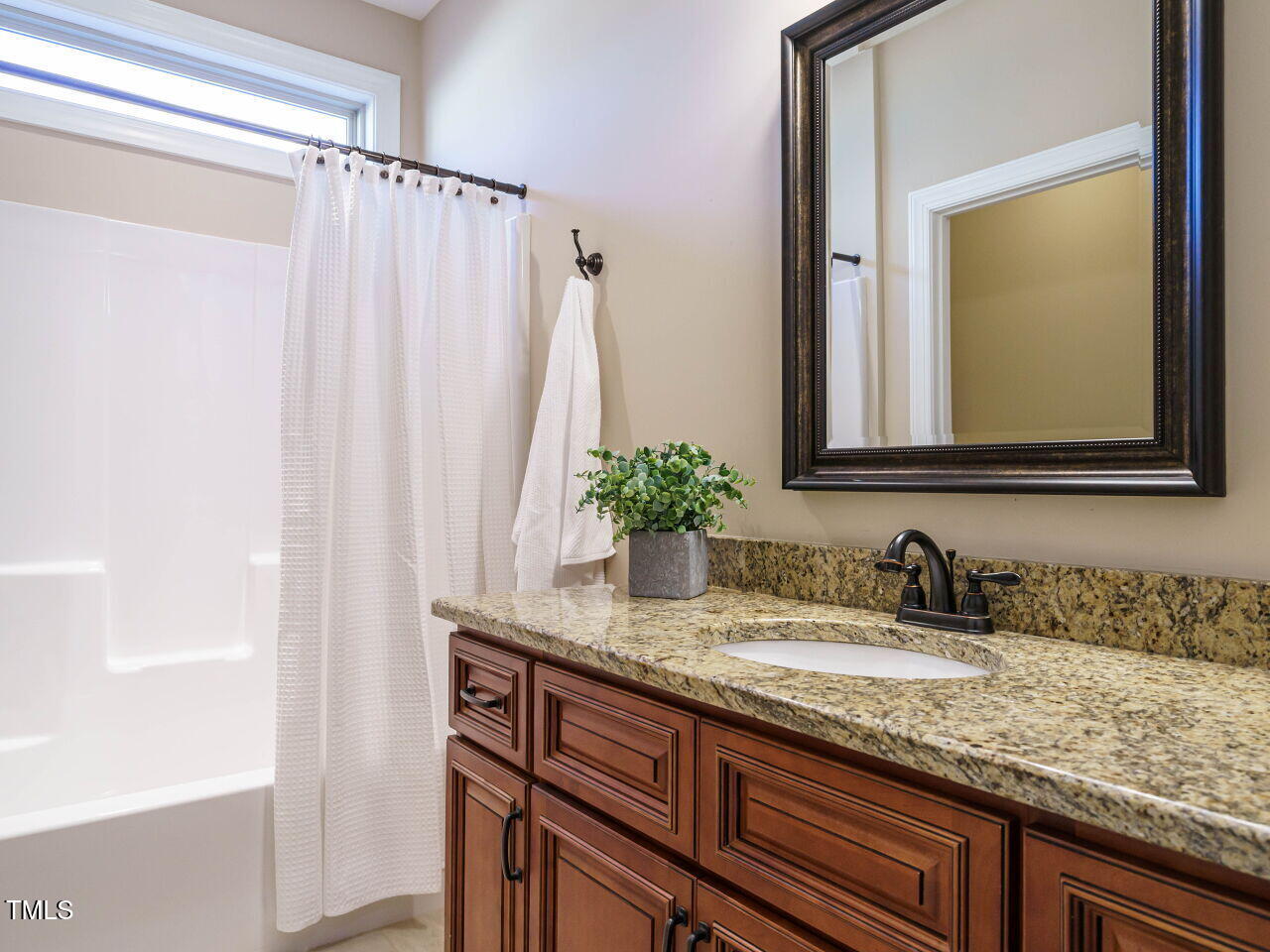 116 Telluride Trail Garner, NC 27529 - Photo 23 of 40 a bathroom with a granite countertop sink and a mirror
