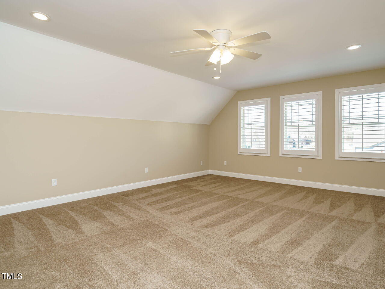 116 Telluride Trail Garner, NC 27529 - Photo 26 of 40 an empty room with chandelier fan and windows