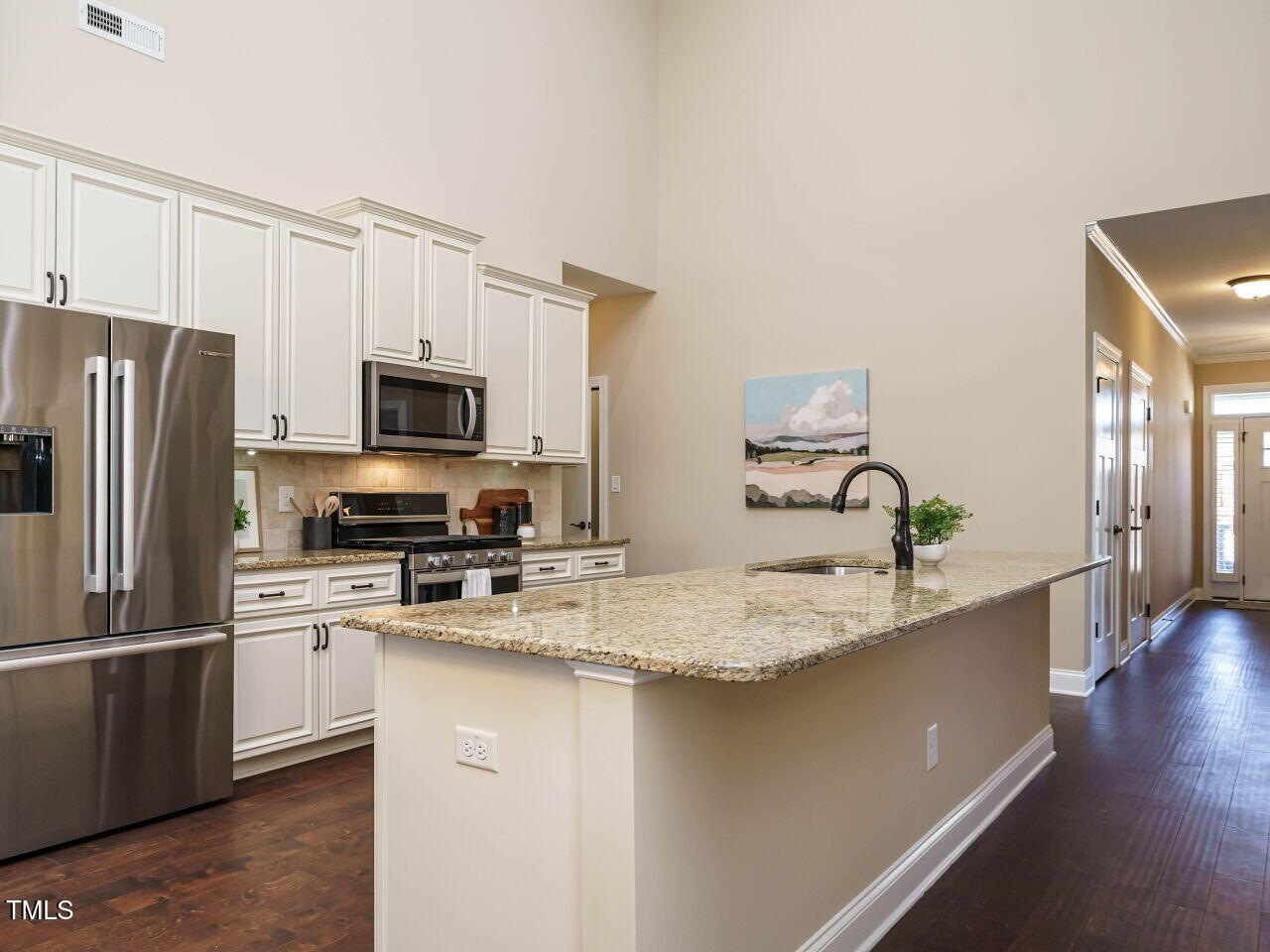 116 Telluride Trail Garner, NC 27529 - Photo 9 of 40 a kitchen with stainless steel appliances granite countertop a sink refrigerator and microwave