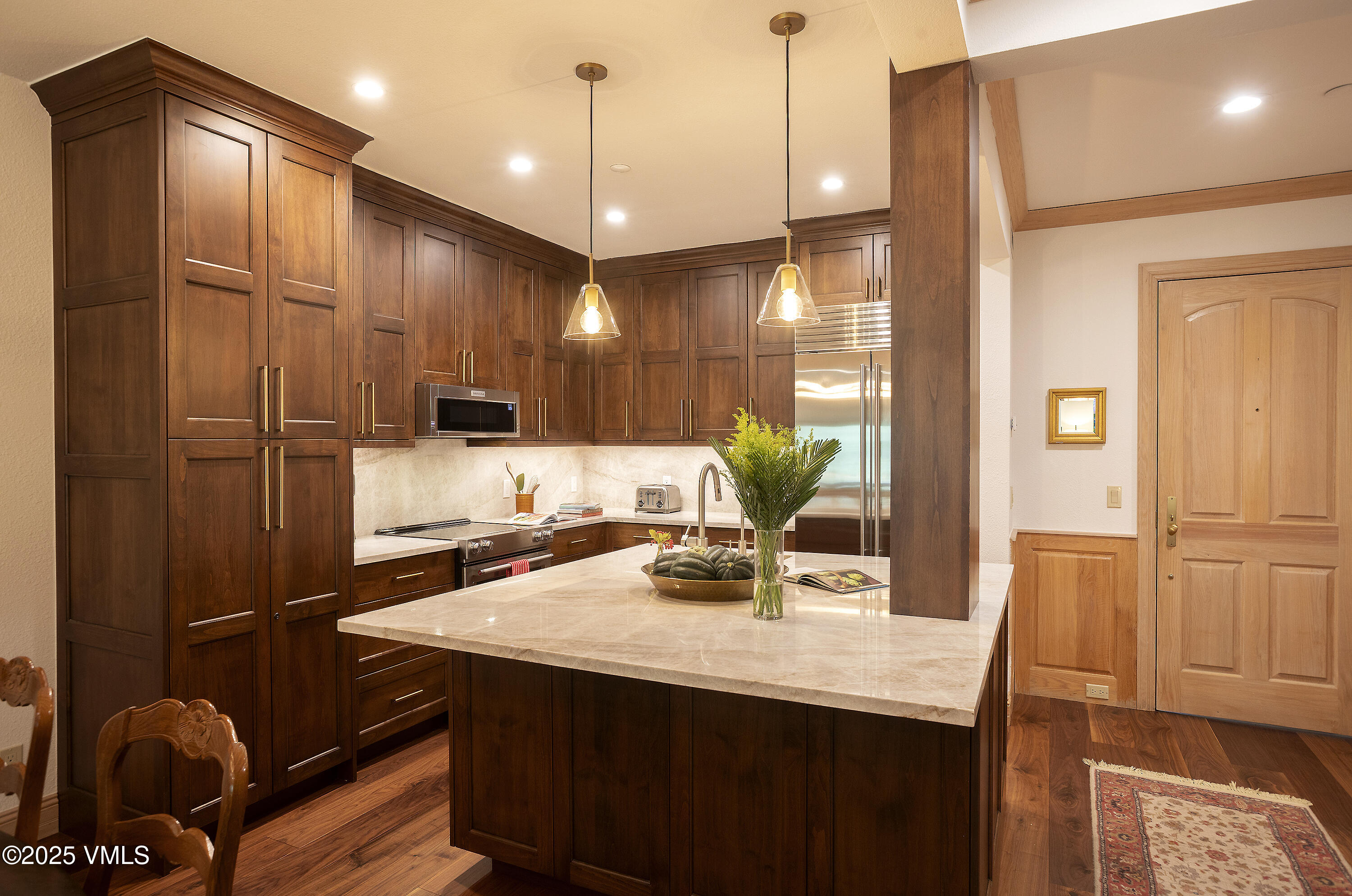 a kitchen with kitchen island granite countertop a sink cabinets and stainless steel appliances