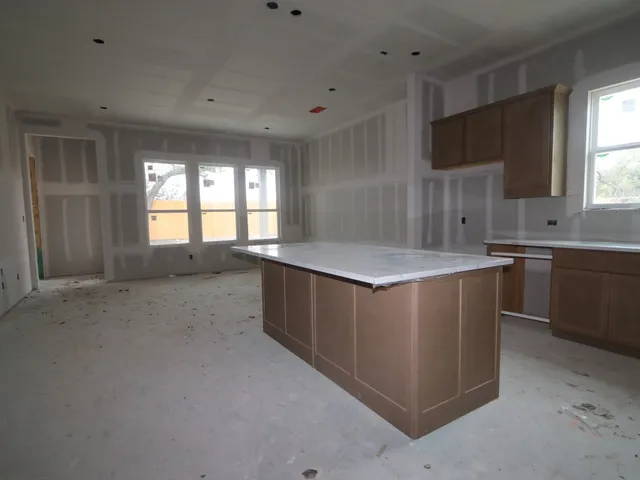 a large kitchen with lot of cabinets and a sink