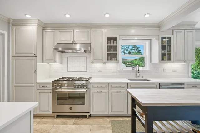 a kitchen with a stove sink and refrigerator