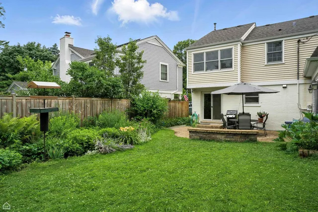 a front view of a house with a yard table and chairs