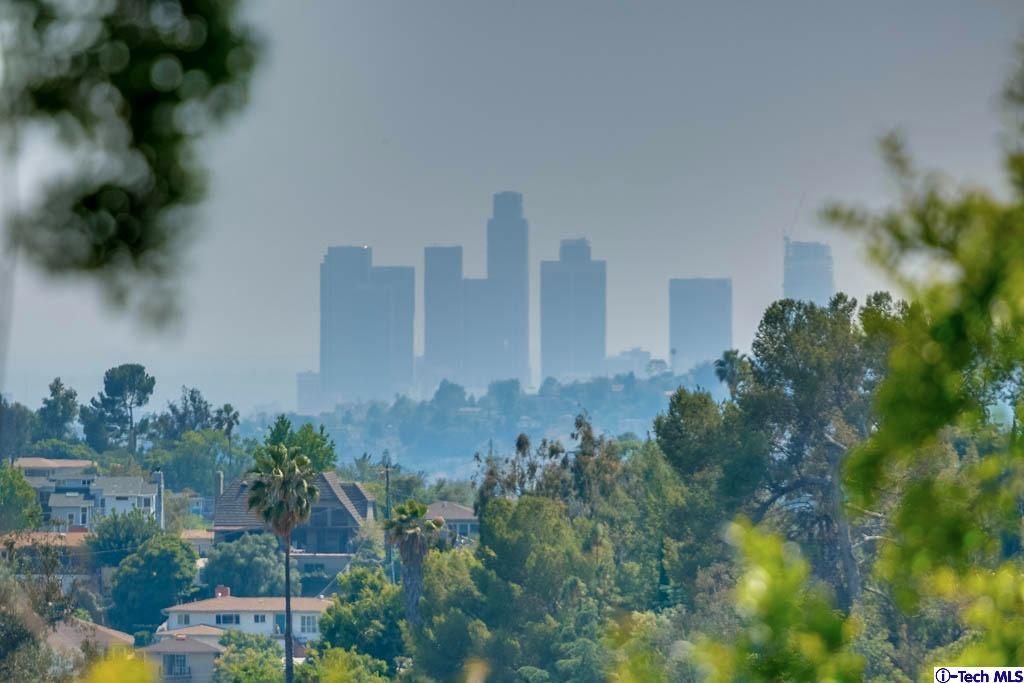 1199 Chateau Road Pasadena, CA 91105 - Photo 2 of 34 a view of a lake with a building in the background