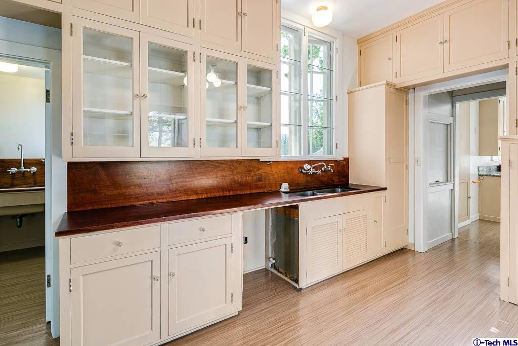 1199 Chateau Road Pasadena, CA 91105 - Photo 12 of 34 a kitchen with granite countertop white cabinets and a sink
