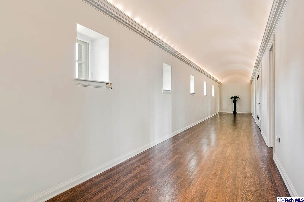 1199 Chateau Road Pasadena, CA 91105 - Photo 14 of 34 a view of a hallway with wooden floor and a bathroom