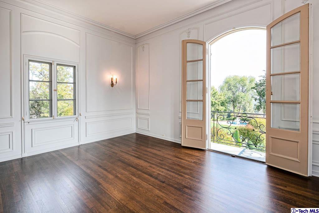 1199 Chateau Road Pasadena, CA 91105 - Photo 17 of 34 an empty room with wooden floor and windows