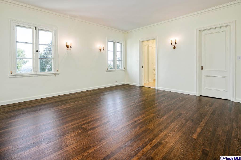 1199 Chateau Road Pasadena, CA 91105 - Photo 24 of 34 an empty room with wooden floor and windows