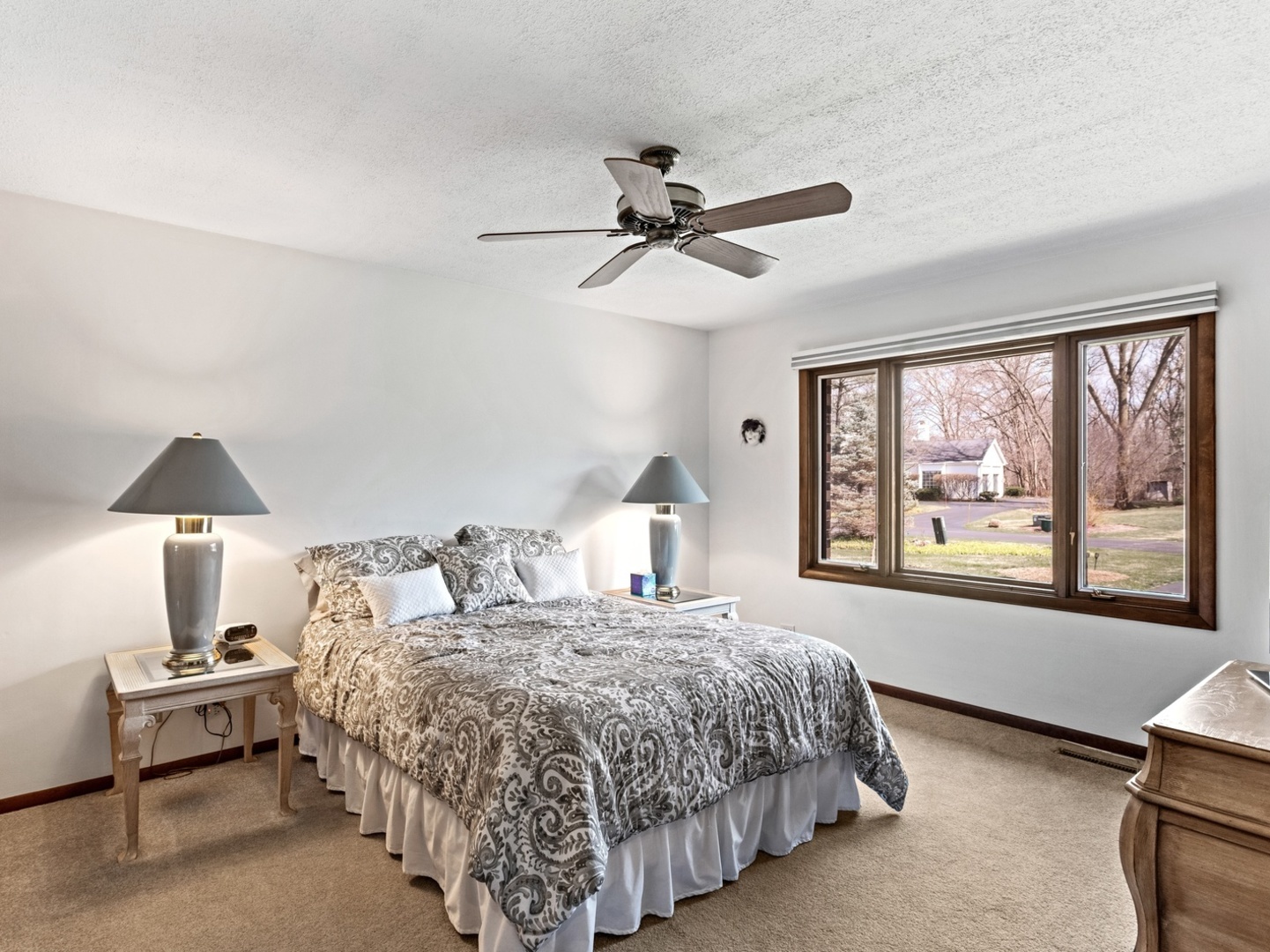 470 East Westleigh Road Lake Forest, IL 60045 - Photo 18 of 28 a bedroom with a large bed and a chandelier fan