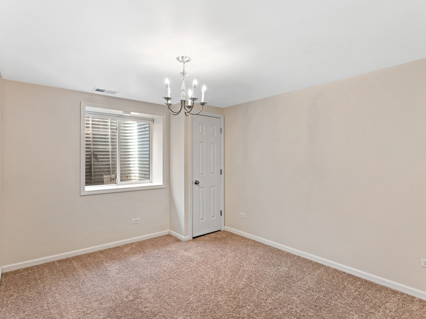 470 East Westleigh Road Lake Forest, IL 60045 - Photo 21 of 28 en empty room with windows and chandelier fan