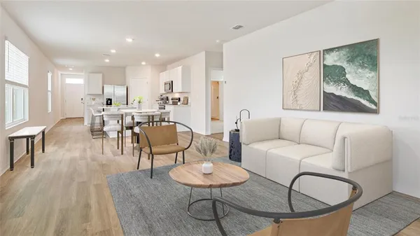 a living room with furniture and a dining table