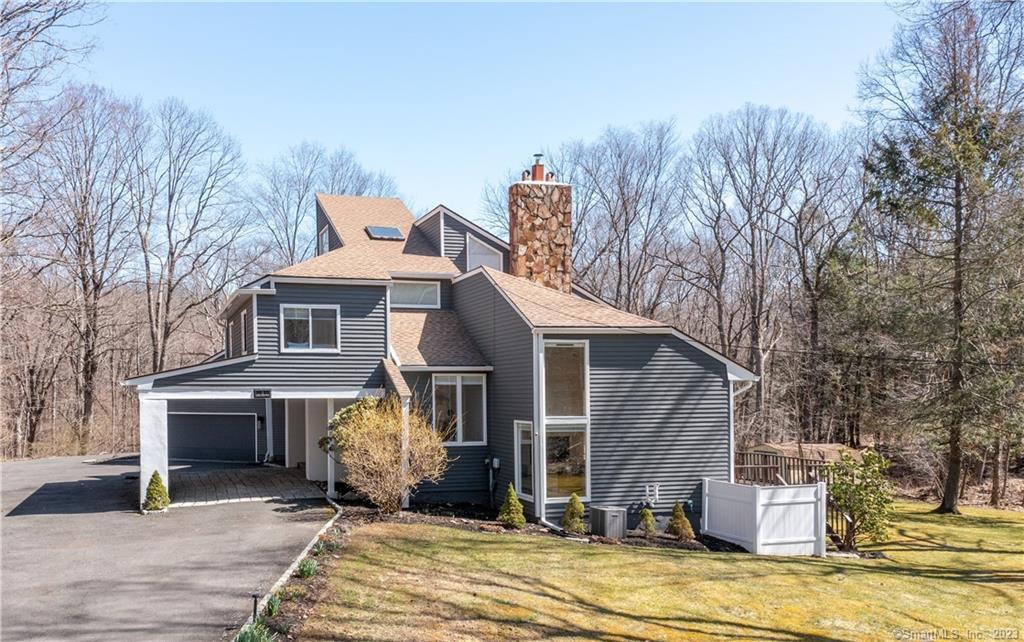 a front view of a house with a yard garage and outdoor seating