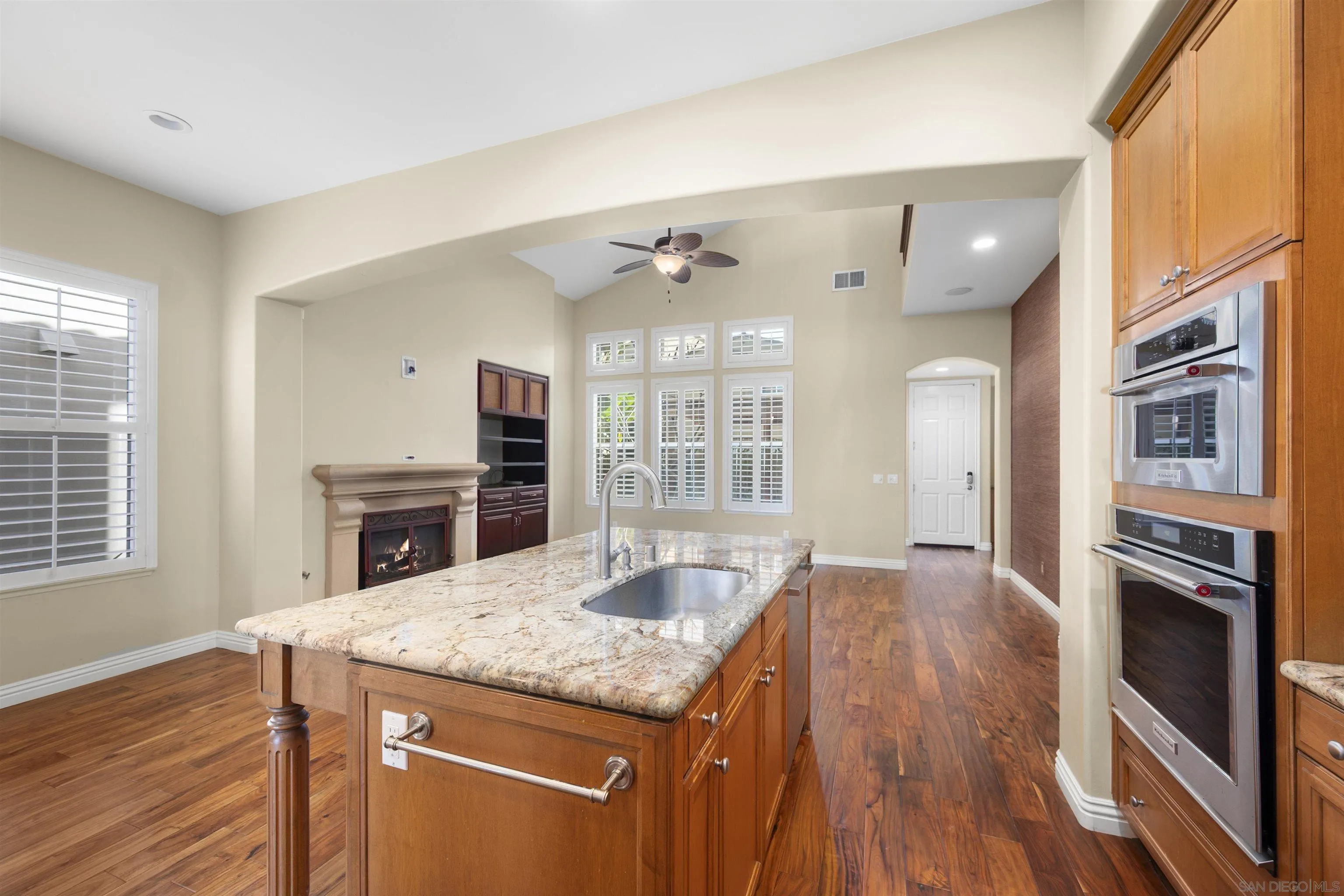 2873 West Bainbridge Road San Diego, CA 92106 - Photo 13 of 54 a kitchen with granite countertop center island wooden floor and stainless steel appliances