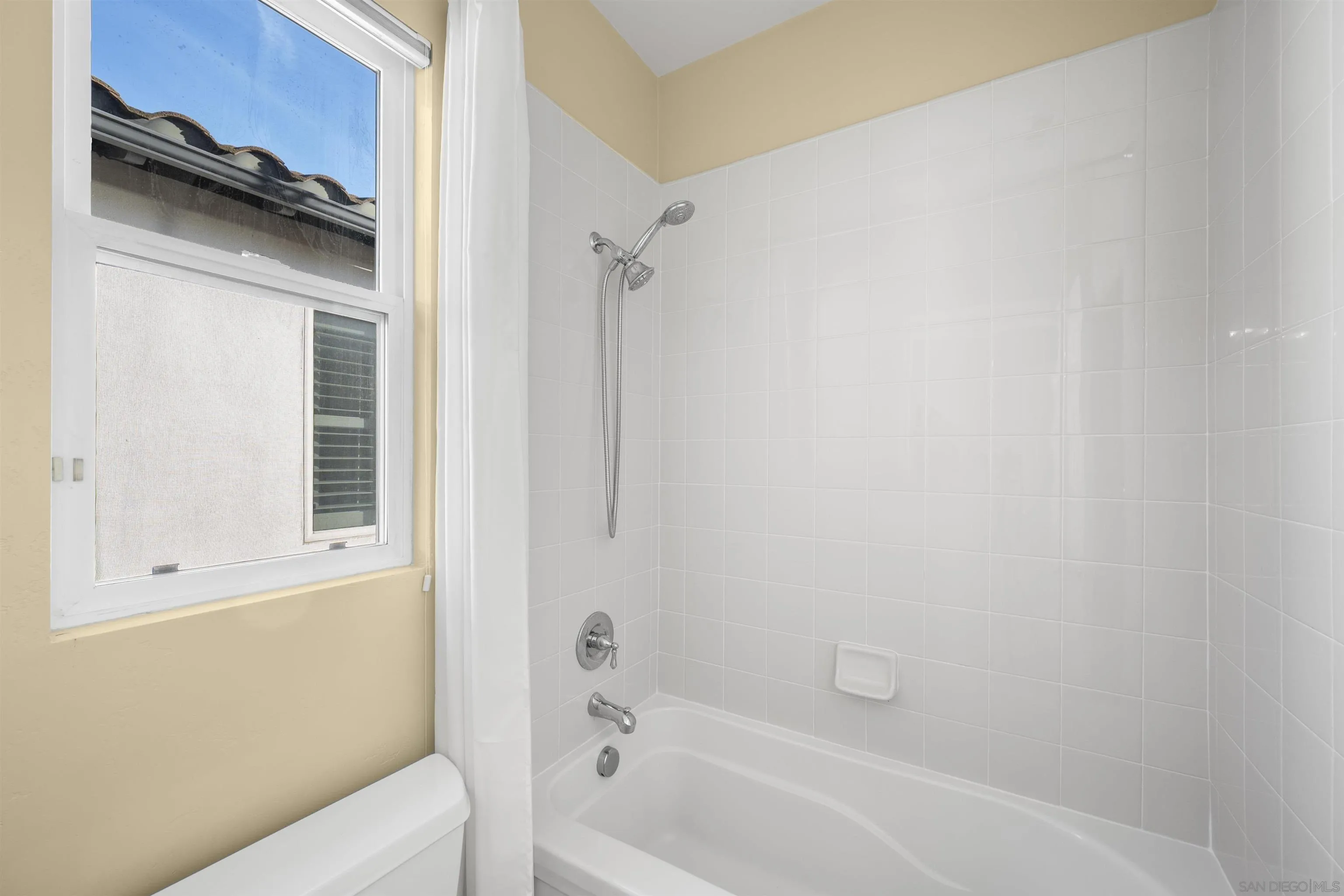 2873 West Bainbridge Road San Diego, CA 92106 - Photo 36 of 54 a bathroom with a bathtub and a shower