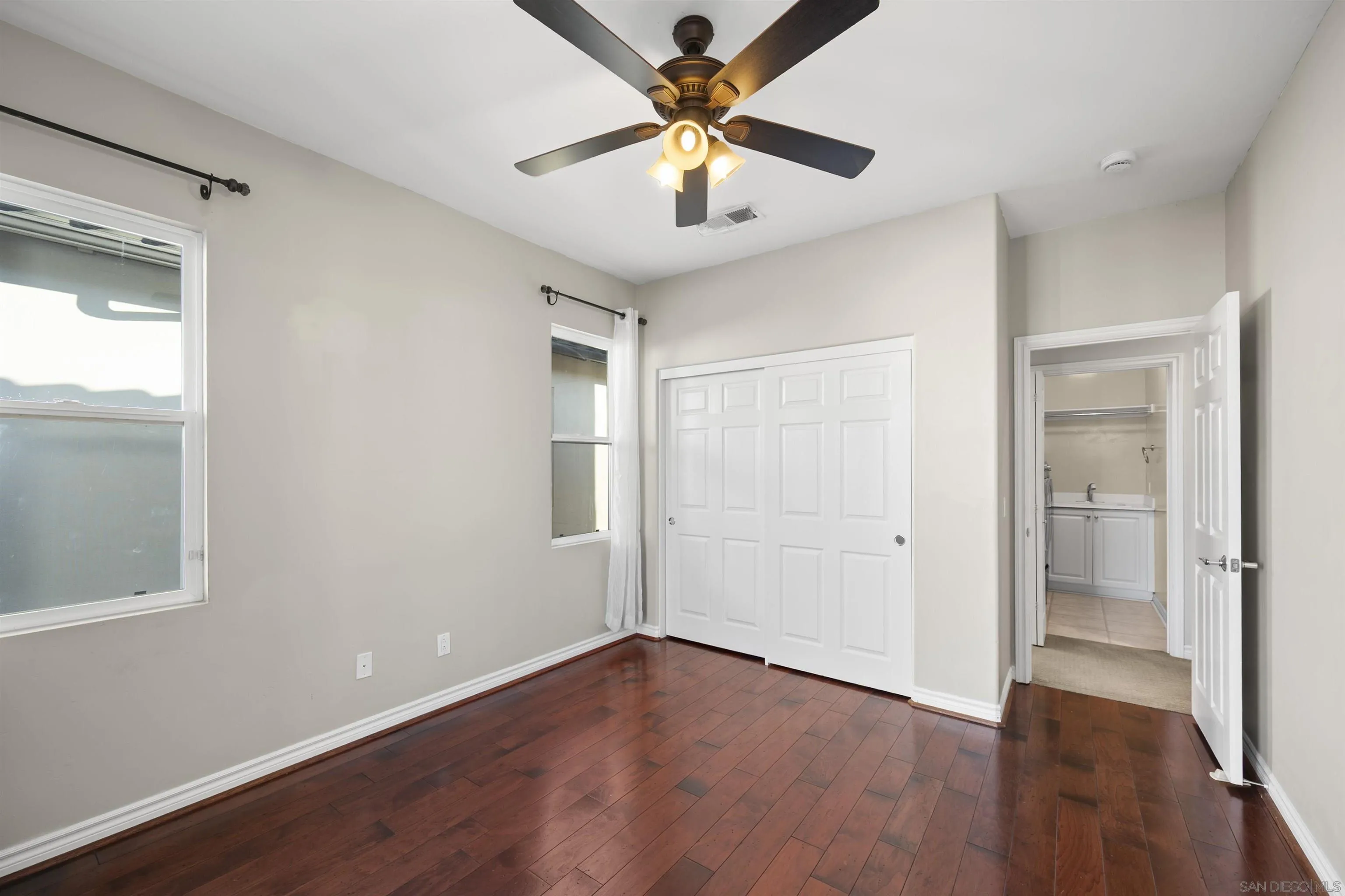 2873 West Bainbridge Road San Diego, CA 92106 - Photo 38 of 54 a view of an empty room with window and wooden floor