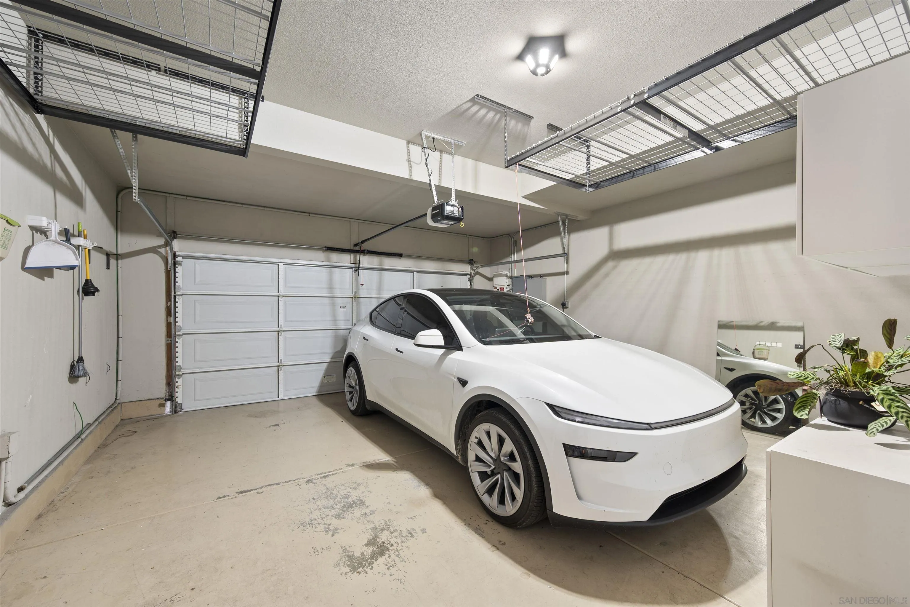 2873 West Bainbridge Road San Diego, CA 92106 - Photo 46 of 54 a car and bike parked in a garage