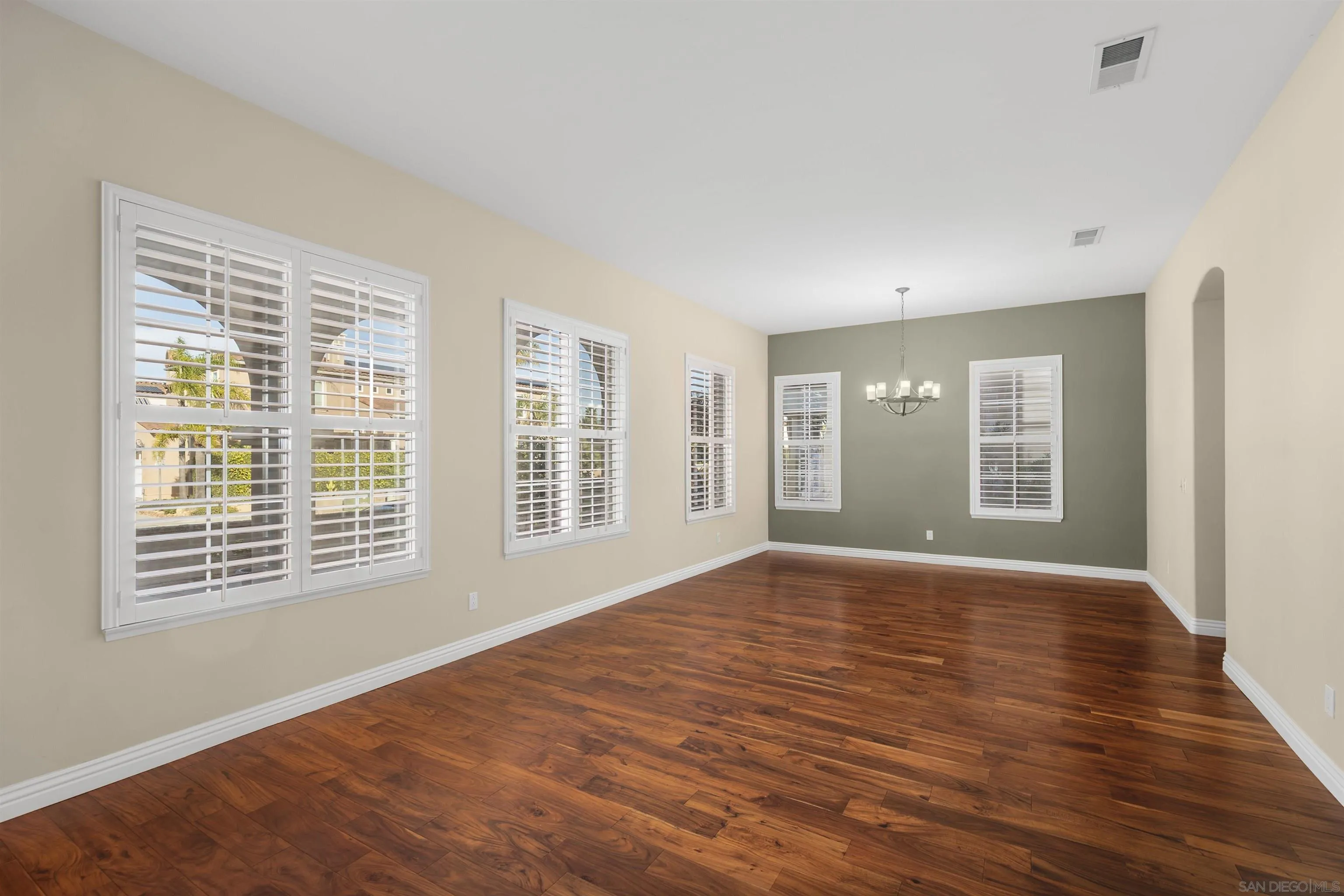 2873 West Bainbridge Road San Diego, CA 92106 - Photo 9 of 54 a view of an empty room with a window and wooden floor