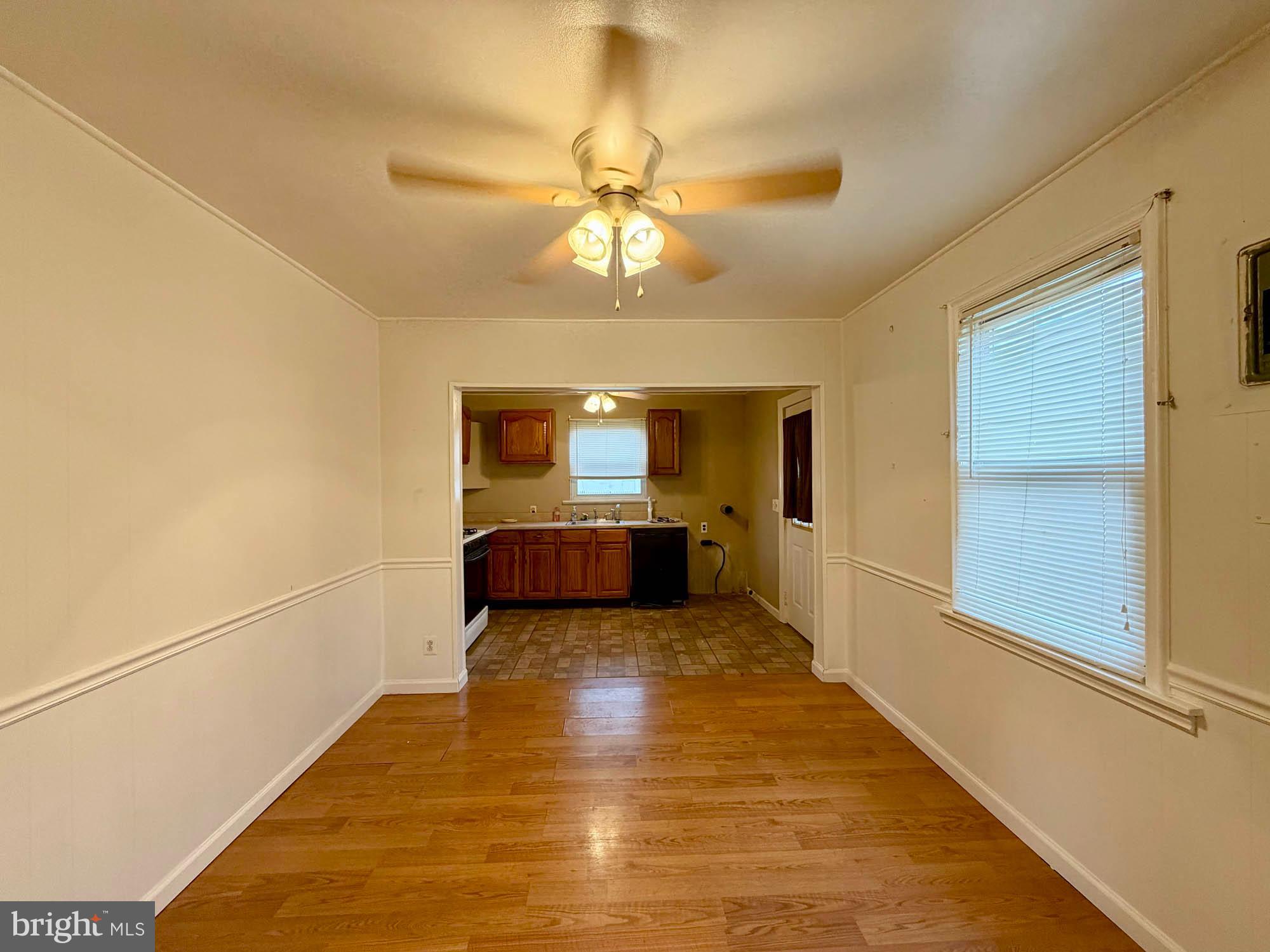 54 Riverside Road Baltimore, MD 21221 - Photo 3 of 14 a view of a room with wooden floor and ceiling fan