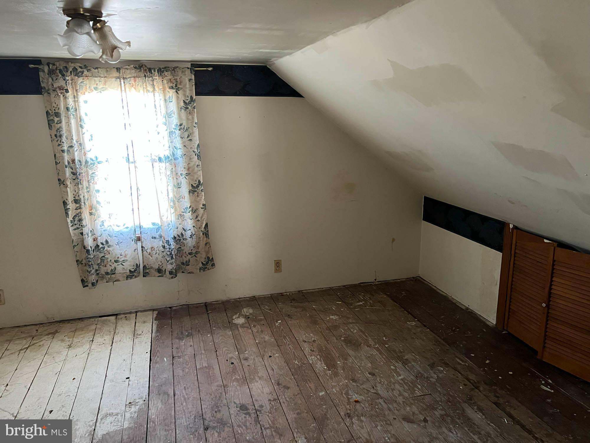 54 Riverside Road Baltimore, MD 21221 - Photo 9 of 14 a view of empty room with wooden floor and fan