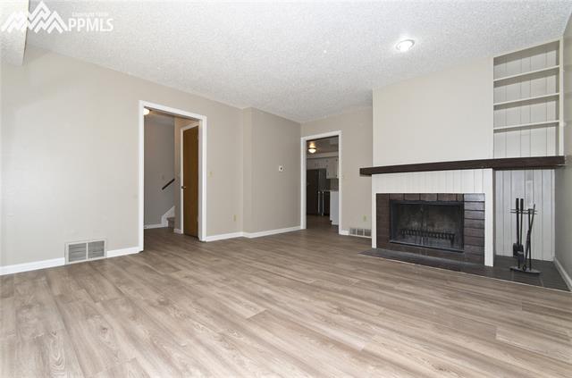 383 Raspberry Lane Monument, CO 80132 - Photo 6 of 36 Large Great Room with NEW easy-care luxury vinyl flooring