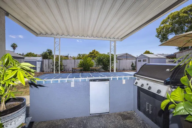 a living room with furniture a potted plant and outdoor seating