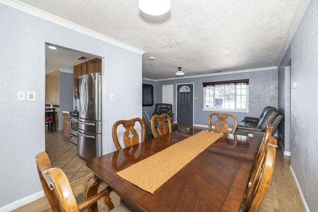 a view of a dining room with furniture a couch and wooden floor