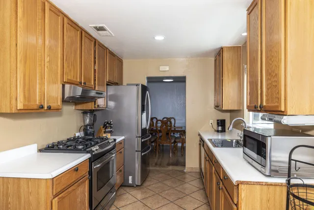 a kitchen with a sink stove and cabinets