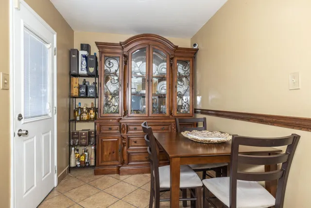 a view of a dining room with furniture and chandelier