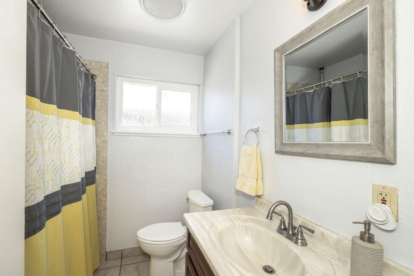 27906 Thackeray Avenue Hayward, CA 94544 - Photo 10 of 14 a bathroom with a sink toilet and mirror