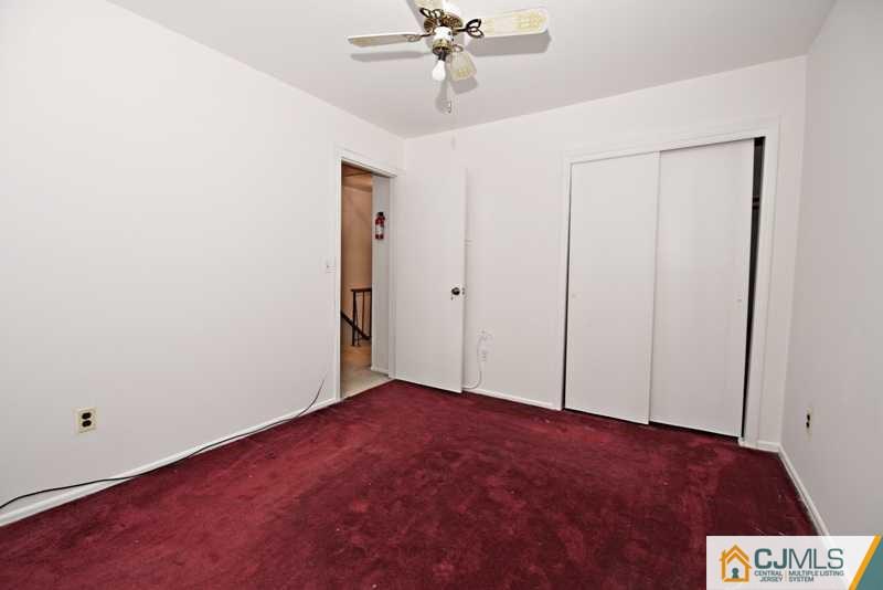 A9 Georges Road, Unit 9 Dayton, NJ 08810 - Photo 13 of 20 an empty room with a ceiling fan and carpet
