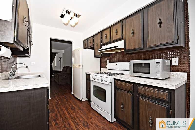 A9 Georges Road, Unit 9 Dayton, NJ 08810 - Photo 14 of 20 a kitchen with stainless steel appliances granite countertop a stove a sink and a microwave