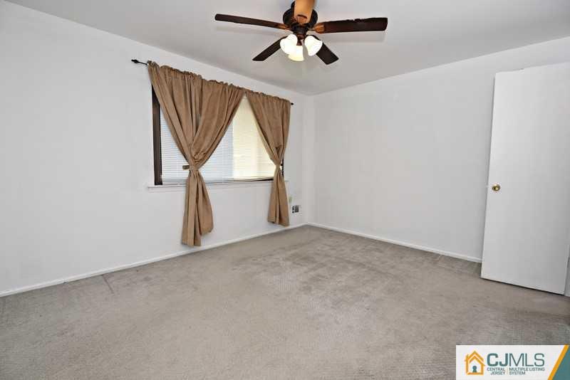 A9 Georges Road, Unit 9 Dayton, NJ 08810 - Photo 16 of 20 an empty room with windows and fan