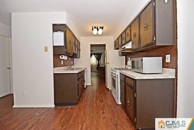 A9 Georges Road, Unit 9 Dayton, NJ 08810 - Photo 17 of 20 a kitchen with stainless steel appliances granite countertop a refrigerator a stove and a wooden floors