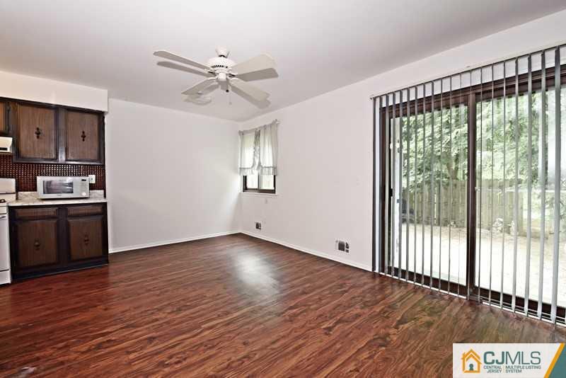 A9 Georges Road, Unit 9 Dayton, NJ 08810 - Photo 18 of 20 a view of an empty room with a window and wooden floor