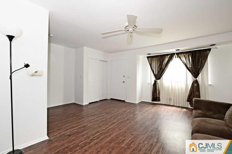 A9 Georges Road, Unit 9 Dayton, NJ 08810 - Photo 3 of 20 a view of a livingroom with wooden floor and ceiling fan