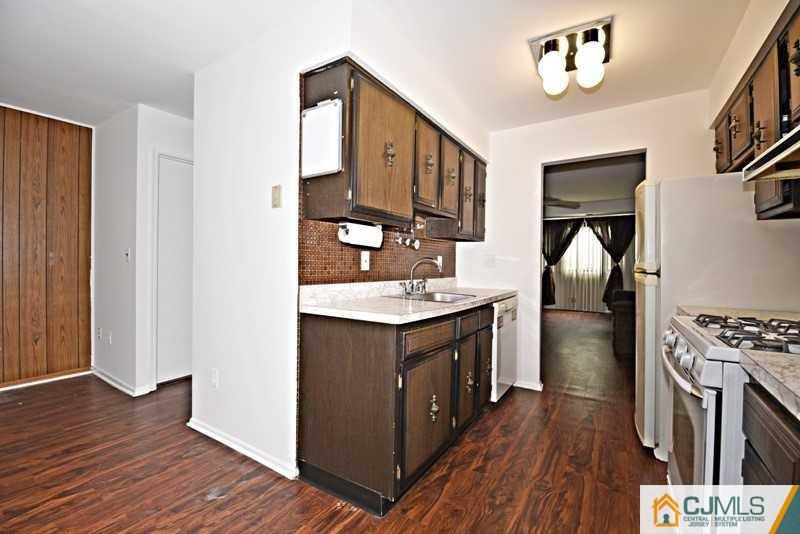 A9 Georges Road, Unit 9 Dayton, NJ 08810 - Photo 4 of 20 a kitchen with stainless steel appliances granite countertop a stove and a refrigerator