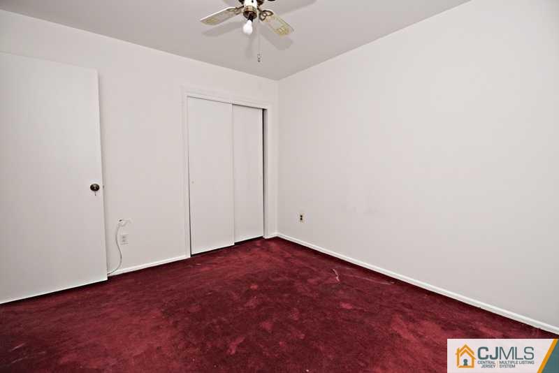 A9 Georges Road, Unit 9 Dayton, NJ 08810 - Photo 5 of 20 an empty room with a chandelier fan