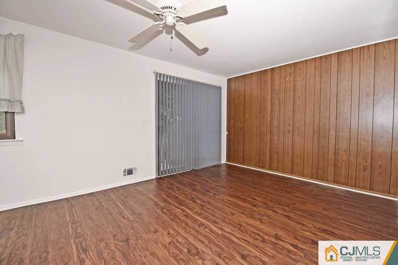 A9 Georges Road, Unit 9 Dayton, NJ 08810 - Photo 6 of 20 a view of an empty room with wooden floor