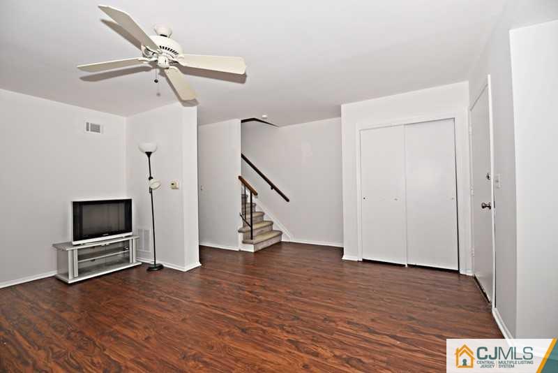 A9 Georges Road, Unit 9 Dayton, NJ 08810 - Photo 7 of 20 a view of empty room with wooden floor and fan