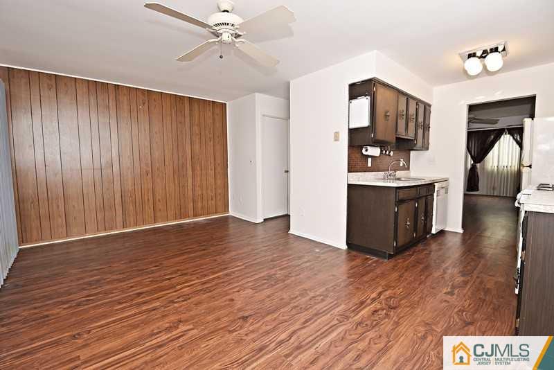 A9 Georges Road, Unit 9 Dayton, NJ 08810 - Photo 9 of 20 a view of a kitchen with wooden floor and a ceiling fan