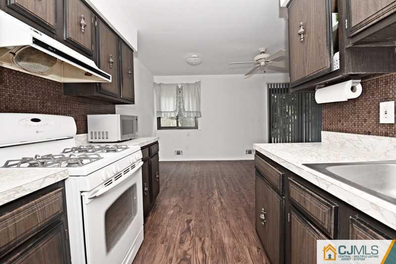 A9 Georges Road, Unit 9 Dayton, NJ 08810 - Photo 10 of 20 a kitchen with a stove and a sink