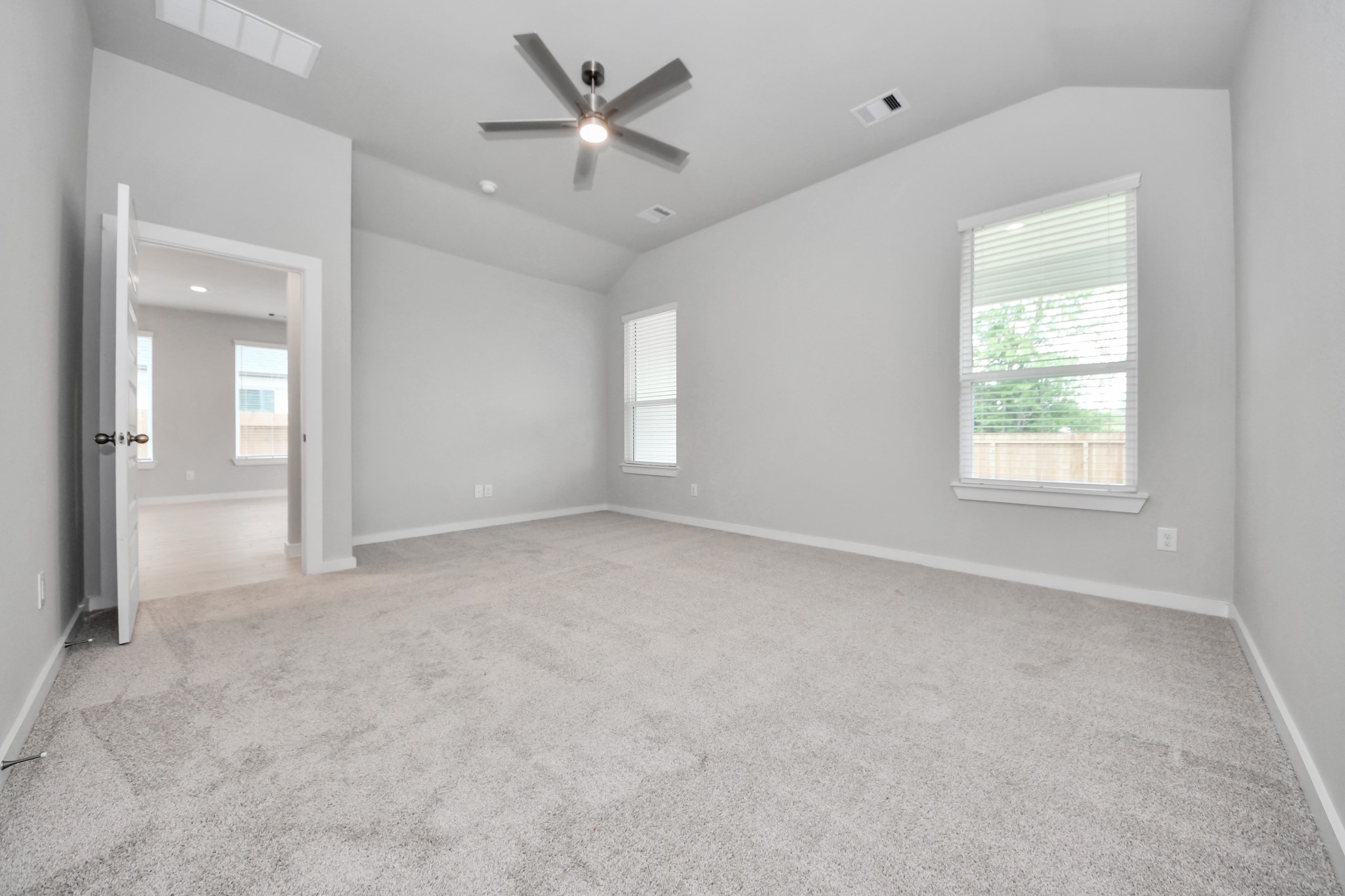 2946 Burris Park Drive Spring, TX 77373 - Photo 25 of 45 Escape to tranquility in this spacious primary room, adorned with plush carpeting and bathed in the soothing hues of warm paint colors, creating a cozy retreat for relaxation.