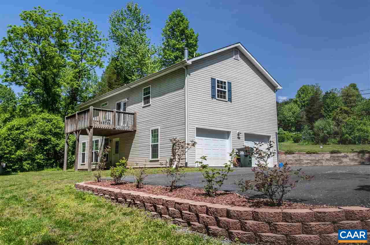 251 Morning Glory Road Ruckersville, VA 22968 - Photo 4 of 36 a front view of a house with garden