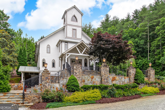 1760 Rickman Airfield Road Tiger, GA 30576 - Photo 2 of 38 a front view of a house with a garden