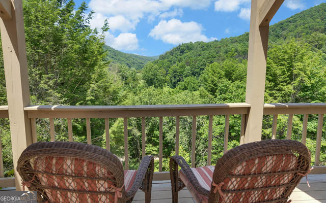 1760 Rickman Airfield Road Tiger, GA 30576 - Photo 24 of 38 a view of balcony with a swing and wooden fence