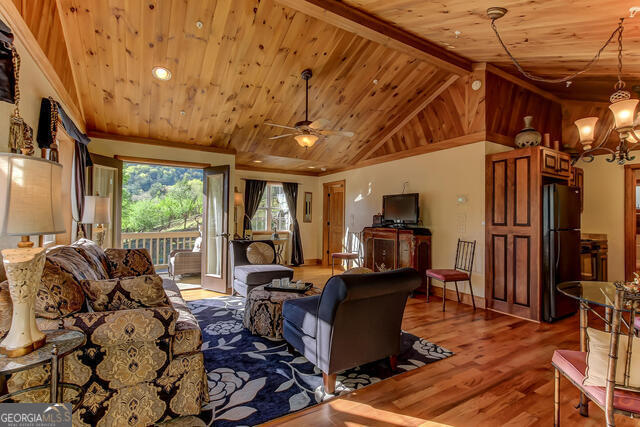 1760 Rickman Airfield Road Tiger, GA 30576 - Photo 26 of 38 a living room with furniture a flat screen tv and floor to ceiling window