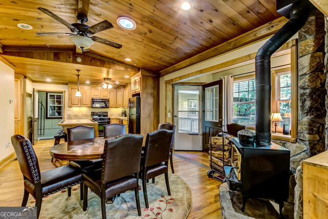 1760 Rickman Airfield Road Tiger, GA 30576 - Photo 30 of 38 a dining room with furniture a chandelier and wooden floor