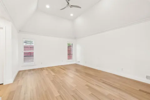 a view of a room with wooden floor and windows